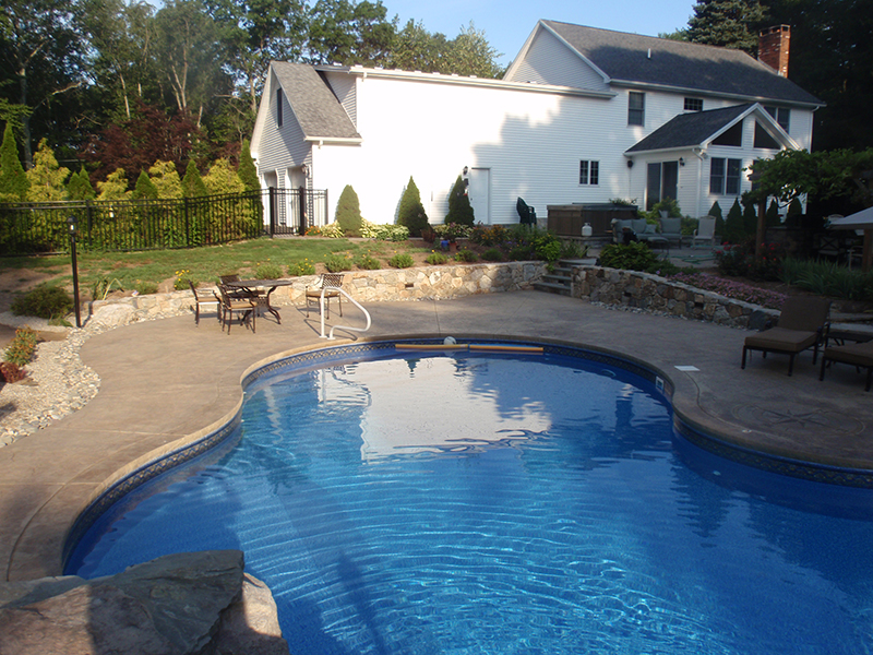 Natural stone wall project enhancing the structure and character of a residential landscape